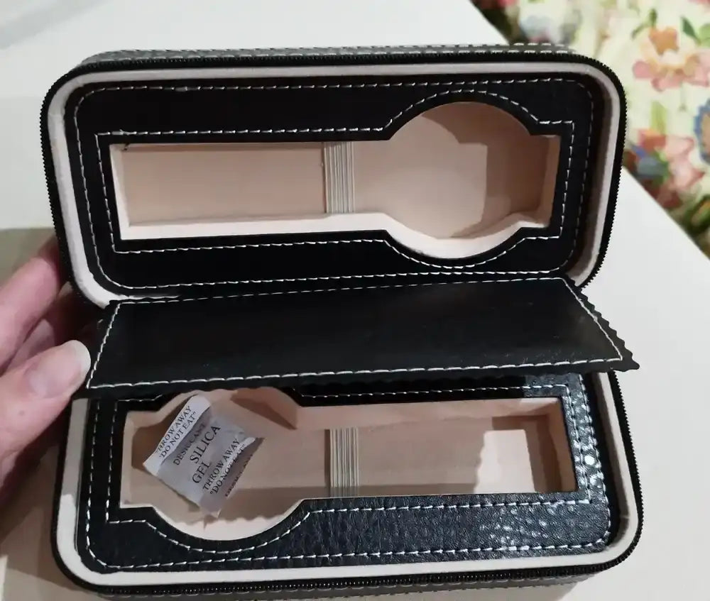 Open black leather watch case.