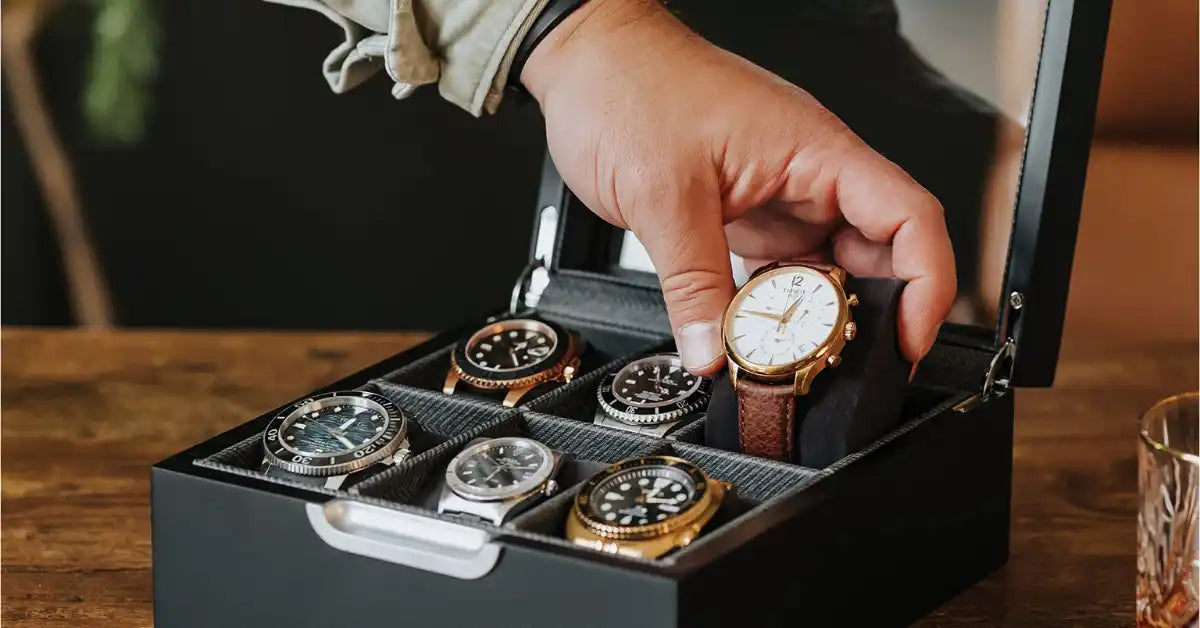 Black watch box with multiple watches.