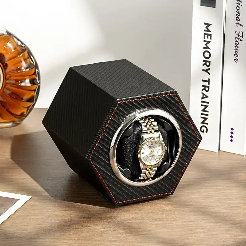 Hexagonal watch winder with a gold and silver watch.