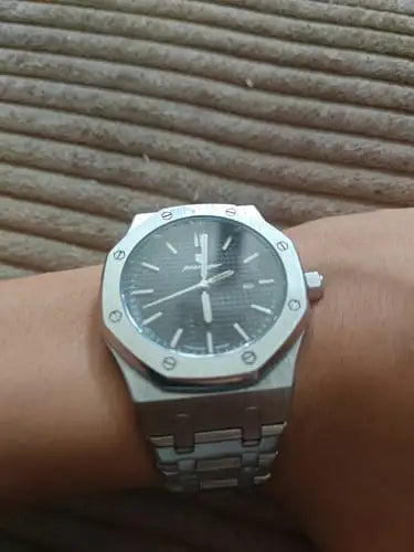 Silver-toned audemars piguet royal oak watch with a dark gray dial and stainless steel bracelet.