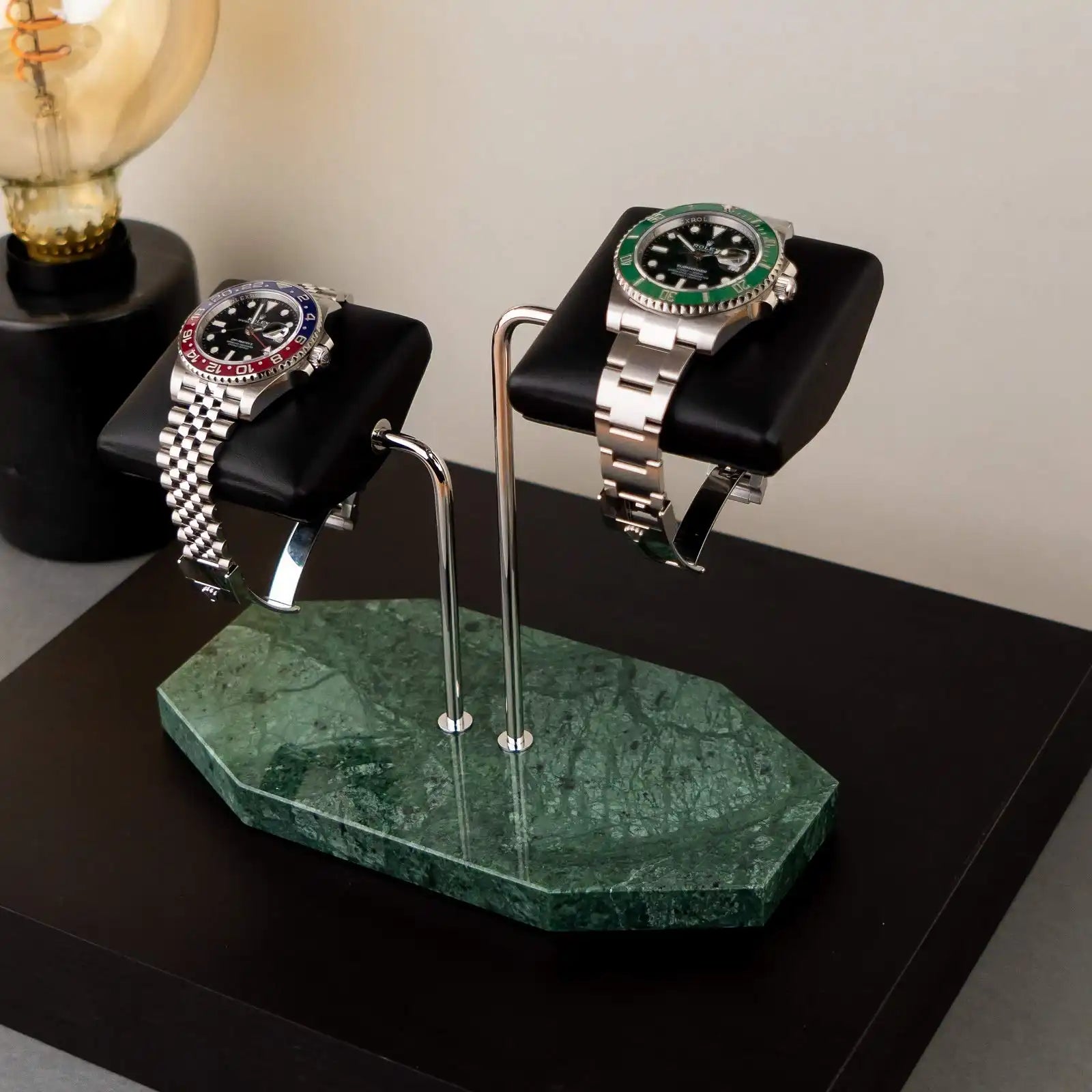 Two-watch display stand with marble base.